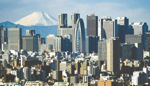 Mount Fuji stands beyond buildings in Tokyo. Wall Street and Japanu2019s largest banks are starting to see eye to eye on the yenu2019s outlook, saying its advance could break the barrier of 100 per dollar next year.