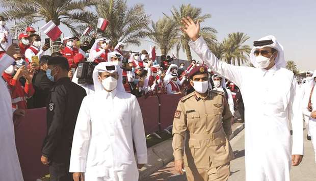 His Highness the Amir Sheikh Tamim bin Hamad al-Thani greets the spectators after the parade.