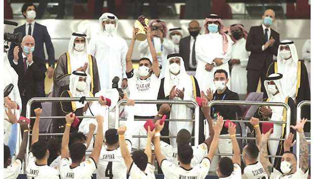 His Highness the Amir Sheikh Tamim bin Hamad al-Thani applauds as Al Sadd captain Hassan al-Haydos lifts the Amir Cup trophy at the Ahmad Bin Ali Stadium.