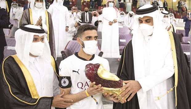 His Highness the Amir Sheikh Tamim bin Hamad al-Thani presents the Amir Cup trophy to Al Sadd captain Hassan al-Haydos after Al Sadd beat Al Arabi in the final at Ahmad Bin Ali Stadium in Al Rayyan on Friday