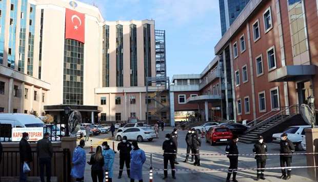 Police and security personnel stand guard outside the private Sanko University Hospital where a fire broke out in the coronavirus disease intensive care unit, in Gaziantep, Turkey