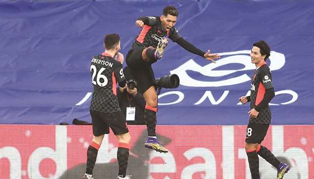 Liverpoolu2019s Roberto Firmino (centre) celebrates with teammates after scoring against Crystal Palace in the Premier League at Selhurst Park in London yesterday.