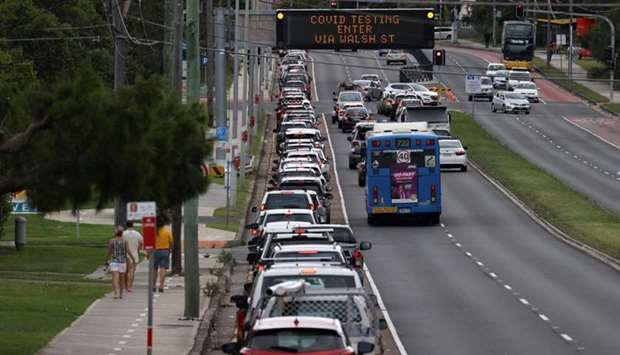Vehicles queue for a drive-through coronavirus disease testing clinic in the Warriewood suburb of Sydney on Friday