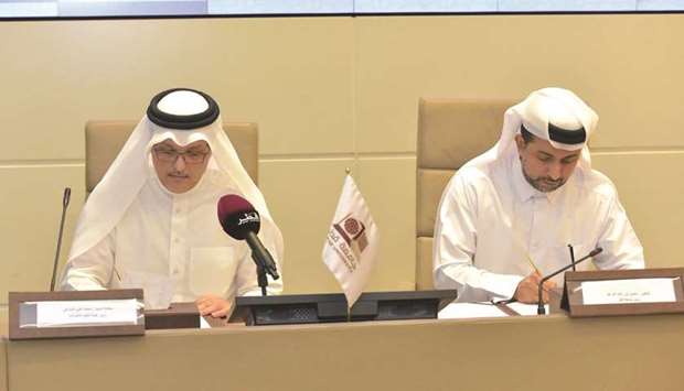 Dr Hassan Rashid al-Derham and Mohamed Ali al-Mannai signing the agreement.