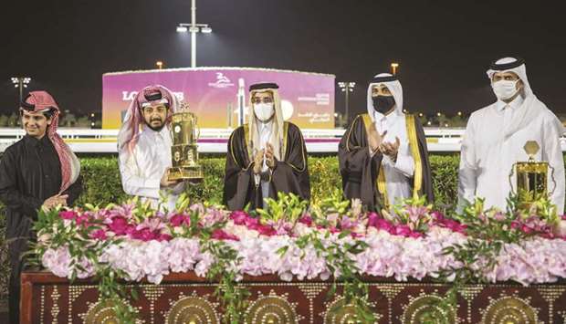 Minister of Culture and Sports HE Salah bin Ghanem bin Nasser al-Ali (centre) applauds after presenting the owneru2019s trophy to Injaaz Stud representative Sheikh Abdullah bin Mishael al-Thani (second from left) in the presence of QREC Chairman HE Issa bin Mohamed al-Mohannadi (second from right) and Qatar and Asian Equestrian Federations President and QREC Vice Chairman Hamad bin Abdulrahman al-Attiyah (right) after Hellenisque won the Qatar Derby (QA Group 1) at Al Rayyan Park yesterday. PICTURES: Juhaim