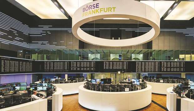 Traders working at the Frankfurt Stock Exchange. The DAX 30 closed 2.8% down at 13,246.30 points yesterday.