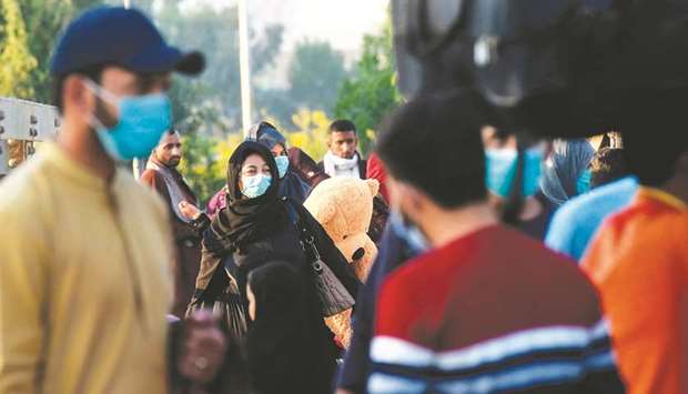 Passengers wearing face masks as a preventive measure against the Covid-19 coronavirus arrive at the Karachi Cantonment Railway Station in the port city of Karachi yesterday. (AFP)