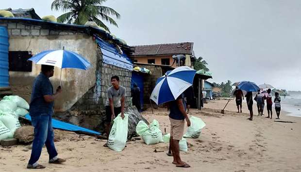 Residents prepare sand bags to protect their homes ahead of cyclone Burevi landfall in Sri Lanka's north-eastern coast, in Trincomalee