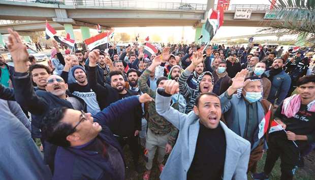 Iraqi protesters take part in a demonstration in the central city of Najaf, yesterday.