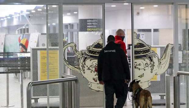 Security guards patrol at the area of the closed Eurostar terminal at Brussels South railway station after Britain's European neighbors began closing their doors to travelers from the United Kingdom amid alarm about a rapidly spreading strain of coronavirus, in Brussels, Belgium