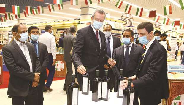 Italian ambassador Alessandro Prunas (centre) views some of the items on display as part of the u2018Letu2019s Eatalianu2019 products promotion at LuLu Hypermarket, Al Messila branch, while (from right) ITA commissioner Giosafat Rigano and Dr Mohamed Althaf, director of LuLu Hypermarket, look on. PICTURE: Jayan Orma