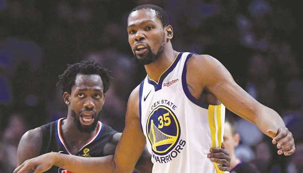 In this April 26, 2019, picture, Kevin Durant (right) of the Golden State Warriors and Patrick Beverley of the LA Clippers talk during Game Six of Round One of the 2019 NBA Playoffs in Los Angeles. (TNS)