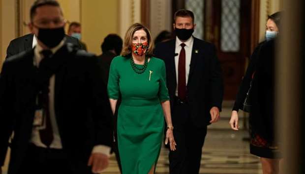 Speaker of the House Nancy Pelosi, walks from the Senate floor as both chambers of Congress are aimed to pass the coronavirus disease  package in a marathon session on Capitol Hill Washington