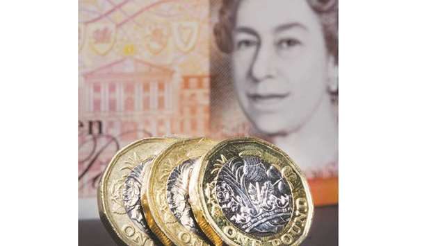 A set of British u00a31 coins sit alongside a British u00a310 banknote in London. Sterling was up around half a percent against the dollar and euro as Londonu2019s FTSE 100 stocks index closed up 0.1% at 6,502.11 points in shortened pre-Christmas trading yesterday.