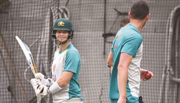 Australiau2019s Steve Smith (L) chats with teammate Josh Hazlewood (R) during a training session in Melbourne yesterday.