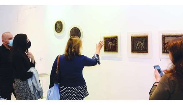 A visitor takes keen interest in the artworks. PICTURES: Thajudheen