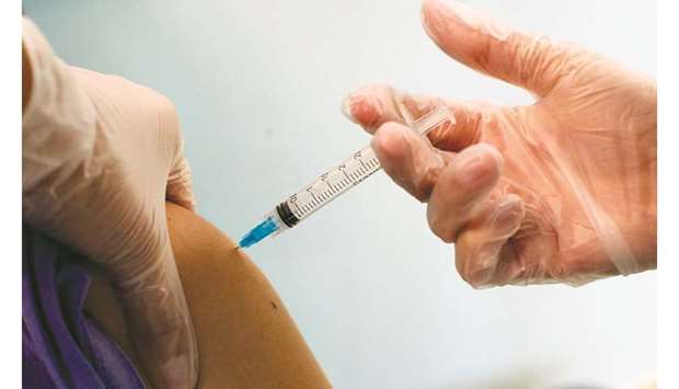 A medical worker receives the Pfizer/BioNTech Covid-19 vaccine jab at Hospital Posta Central in Santiago, yesterday.