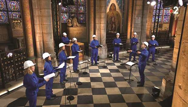 This video frame grab from Images France Televisions shows musicians of the Maitrise Notre-Dame de Paris performing inside the Notre-Dame de Paris Cathedral on Christmas Eve.
