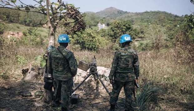 Rwandan peacekeepers of the United Nations Multidimensional Integrated Stabilization Mission in the Central African Republic (MINUSCA) monitor the arrival of rebel groups on National Road 2 north of Bangui, the capital of the Central African Republic
