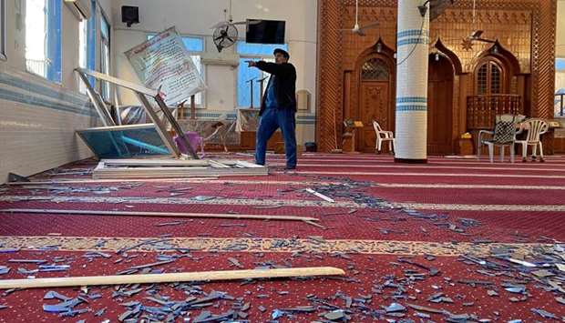 A Palestinian man inspects a mosque damaged in an Israeli air strike in Gaza City