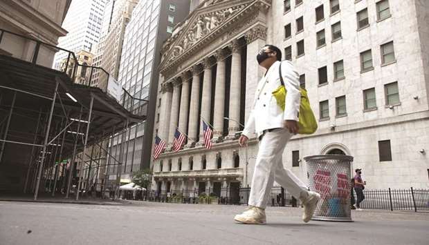 A pedestrian passes in front of the New York Stock Exchange. Worries over a resurgent coronavirus pandemic and upcoming US Senate runoffs in Georgia are clouding the outlook for what has historically been a seasonally strong period for Wall Street equities.