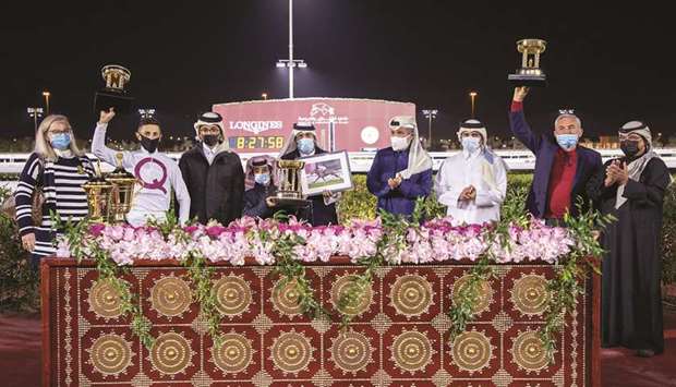 His Highness Sheikh Mohamed bin Khalifa al-Thani (fourth from right) with the winners of His Highness Sheikh Mohamed Bin Khalifa Al Thani Trophy (QA Group 2) after Al Wasmiyah Farmu2019s Noor Al Hawa won the 2,000m feature at Al Rayyan Park yesterday. PICTURES: Juhaim