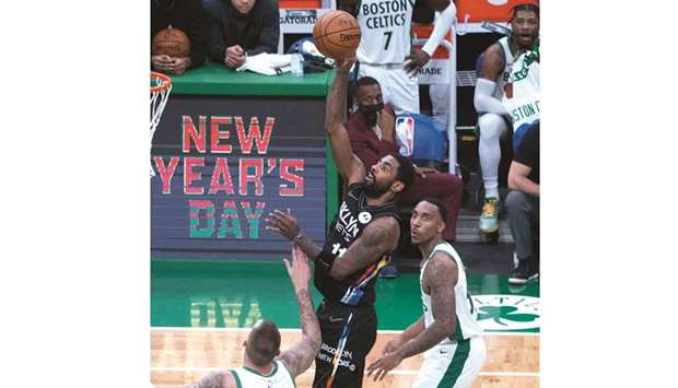 Brooklyn Nets point guard Kyrie Irving (second from right) shoots a hook shot during the third quarter against the Boston Celtics in Boston, Massachusetts, United States, on Friday. (USA TODAY Sports)