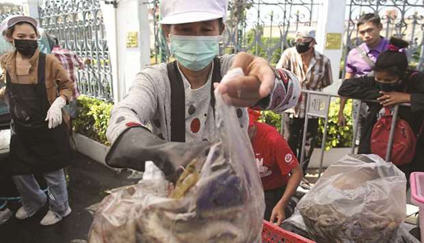 Anti-government protesters sell shrimps in front of the government house as people now fear to eat shrimps due to the coronavirus disease (Covid-19) outbreak in Bangkok, yesterday.
