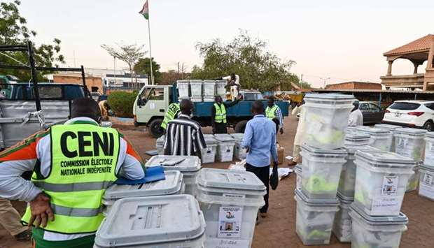 Members of Niger's Independent National Electoral Commission (CENI) load ballot boxes and election equipment onto a truck yesterday in Niamey