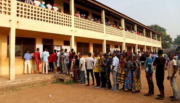 Voters queue to cast their ballots during the presidential and legislative elections at a polling station in Petevo, eighth Arrondissement of Bangui, Central African Republic, yesterday.