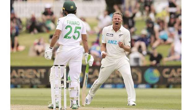New Zealandu2019s paceman Neil Wagner celebrates taking the wicket of Pakistanu2019s Fawad Alam (R) at the Bay Oval in Mount Maunganui yesterday.