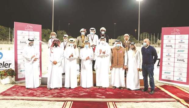 President of the Asian and Qatar Equestrian Federations Hamad bin Abdulrahman al-Attiyah, tournament director Fouad al-Mudahka and QEF Secretary General Ali Al-Rumaihi pose with the podium finishers and other officials at the horseback archery competition (Al Nashaab Championship) at the Qatar Equestrian Federationu2019s outdoor area.