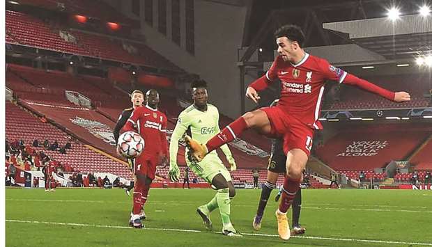 Liverpoolu2019s Curtis Jones (right) scores against Ajax during the Champions League Group D match in Liverpool, north west England on Tuesday. (AFP)