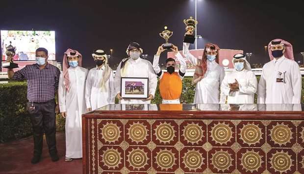 Qatar Racing and Equestrian Clubu2019s Abdulla Rashid al-Kubaisi (second from right) with the winners of Al Shaqab Cup after Injaaz Studu2019s Lekhraib won the 1,700m feature at Al Rayyan Park yesterday. PICTURES: Juhaim