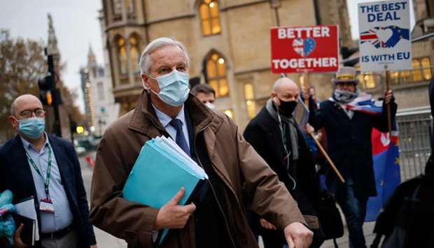 EU chief negotiator Michel Barnier (C), wearing a protective face covering to combat the spread of t