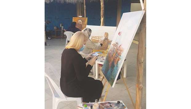 Russian artist Kristina al-Adwan paints her emblematic subject -- the dhow -- at the 10th edition of