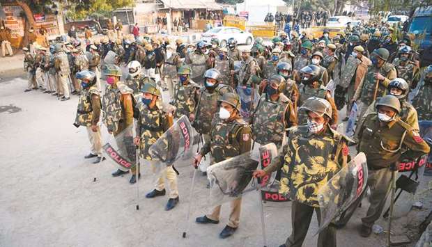 Delhi police and security personnel stand guard as farmers continue to protest against the central governmentu2019s recent agricultural reforms at the Delhi-Haryana state border in Singhu yesterday.