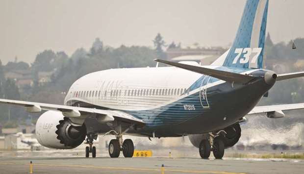The Boeing 737 MAX airplane taxis after landing during a test flight in Seattle on September 30. Dublin-based Ryanair will add to an existing MAX purchase by taking 75 more of the single-aisle aircraft, the companies said in a statement yesterday.