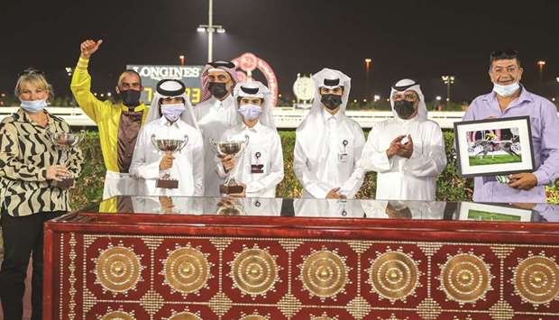 Qatar Racing and Equestrian Clubu2019s Abdulla Rashid al-Kubaisi (second from right) with the winners of Ras Laffan Cup after Seeyoubyme won the feature at Al Rayyan Park yesterday. PICTURES: Juhaim