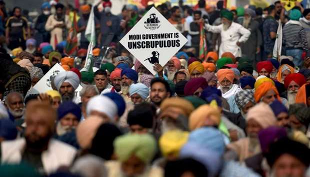 Farmers listen to a speaker as they take part in a protest against the central governmentu2019s recent agricultural reforms at the Delhi-Haryana state border in Singhu on December 4