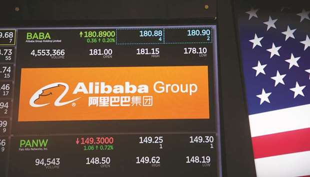 A monitor displays Alibaba Group Holding signage on the floor of the New York Stock Exchange (file). A star-studded cast of global banks and fund houses have increased their presence in China this year and a record $212bn of foreign funds have poured into Chinese bonds and stocks.