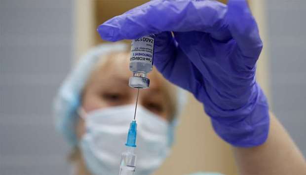 A medical worker fills a syringe with Sputnik V (Gam-COVID-Vac) vaccine before administering an injection during the vaccination against the coronavirus disease (Covid-19) at a clinic in the town of Domodedovo near Moscow, Russia