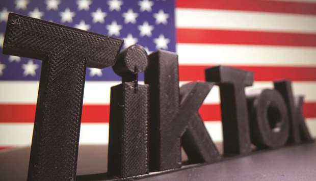 A 3D printed TikTok logo is seen in front of US flag in this illustration taken October 6. TikTok continued serving up short videos in the US despite missing a Trump administration deadline to come up with an acceptable deal to put its American assets into US hands.