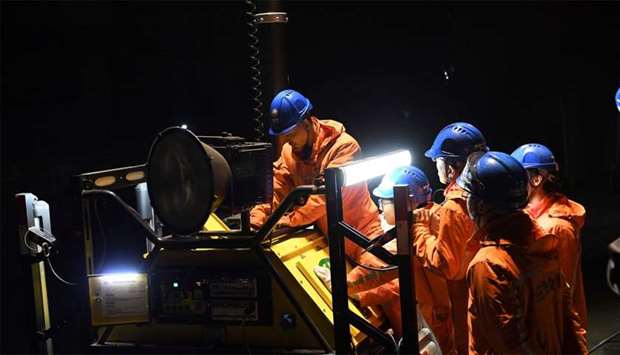 Rescuers adjust an emergency generator at the Diaoshuidong coal mine in southwestern China's Chongqi