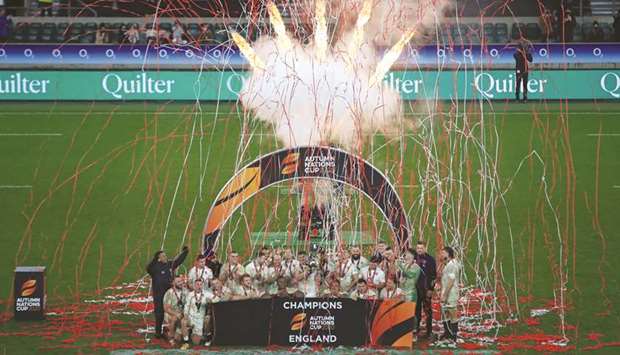Englandu2019s players celebrate after their victory in the final of the Autumn Nations Cup international rugby union series against France at Twickenham, south west London,  yesterday. The game finished 19-19, with England winning after kicking a penalty in sudden death extra-time.  At bottom, a piece of action from the match.