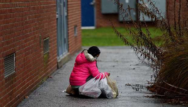A person carries food donated by volunteers from the Baltimore Hunger Project outside of Padonia International Elementary school in Cockeysville, Maryland. More and more children are going hungry in the US as it weathers the worldu2019s worst coronavirus outbreak, which has killed around 280,000 people and caused a once-in-a-generation economic crisis.