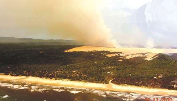 Vegetation burns from a bushfire on Fraser Island (Ku2019gari), Queensland, Australia, in this aerial picture obtained from social media.
