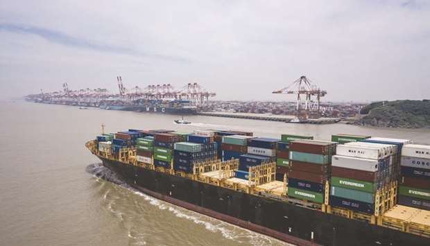 The Kota Cepat vessel loaded with shipping containers approaches the Yangshan Deepwater Port in an aerial photograph taken in Shanghai. Chinau2019s exports jumped in  November by the most since early 2018, pushing its trade surplus to a monthly record high and underlining how global demand for pandemic-related goods is supporting a growth rebound in the worldu2019s second-largest economy.