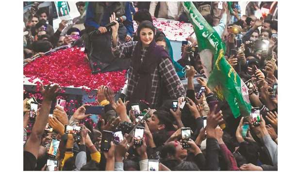 PML-N Vice-President Maryam Nawaz (centre), who is also a frontline PDM leader, gestures to supporters during a rally her party held in Lahore yesterday. (AFP)
