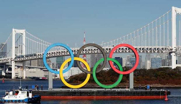 Olympic rings, which were temporarily taken down in August for maintenance amid the coronavirus disease outbreak, are towed by a boat for reinstallation at the waterfront area at Odaiba Marine Park in Tokyo, Japan December 1